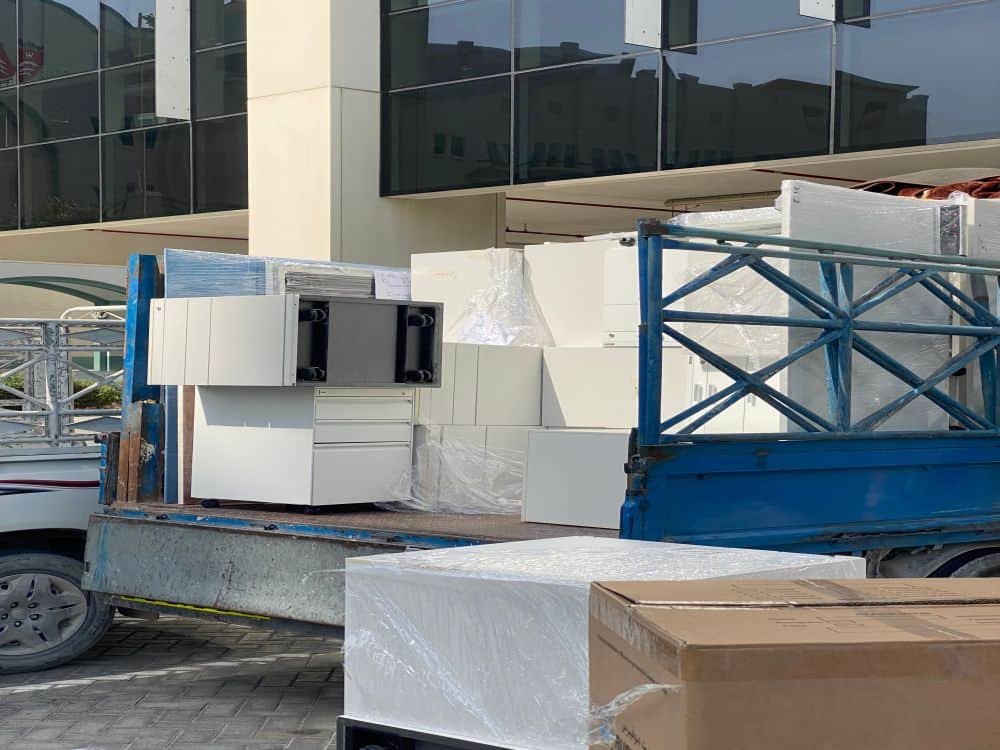 Commercial junk removal truck with furniture and appliances in Dubai.
